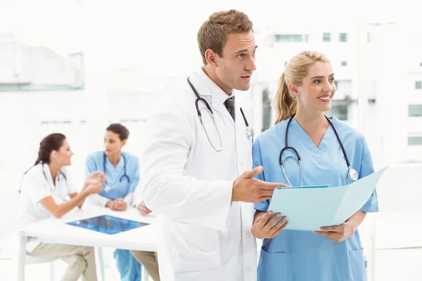 Male doctor and surgeon with reports Stock Image