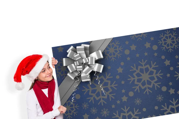 Composite image of festive little girl showing card — Stock Photo, Image