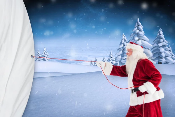 Santa claus pulling a rope — Stock Photo, Image