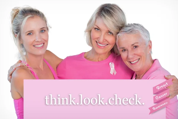 Composite image of women wearing pink tops and ribbons for breas — Stock Photo, Image