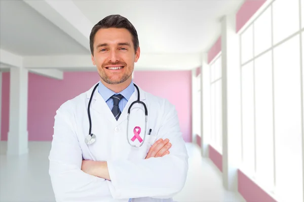 Imagem composta de jovem médico bonito com braços cruzados — Fotografia de Stock