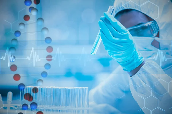 Protected scientist looking at a dangerous liquid — Stock Photo, Image