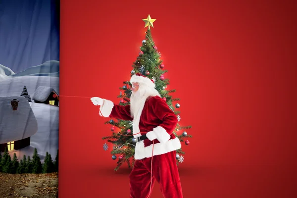 Composite image of santa pulls something with a rope — Stock Photo, Image