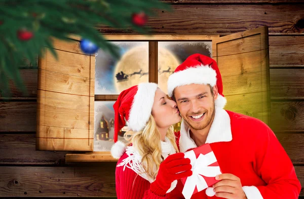 Composite image of young festive couple — Stock Photo, Image