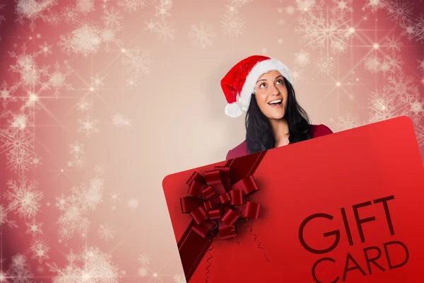 Composite image of woman holding a white sign — Stock Photo, Image