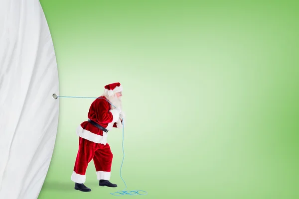Santa claus trekken een touw — Stockfoto