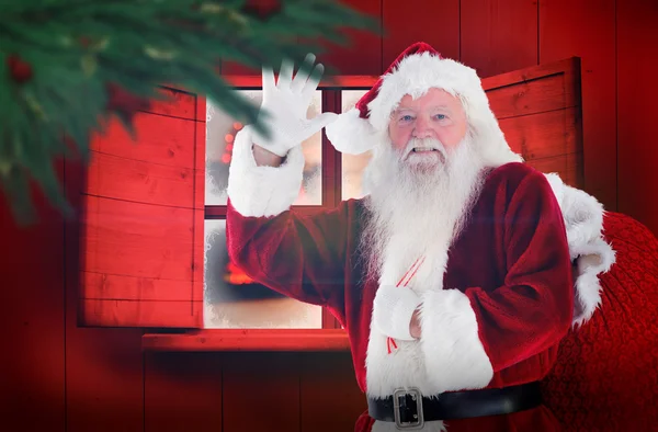 Složený obraz santa claus mává — Stock fotografie