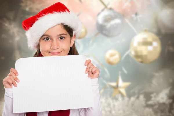 Composite image of festive little girl showing card — Stock Photo, Image