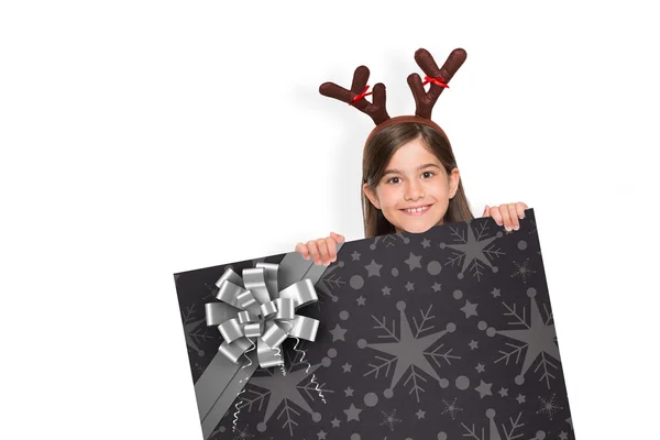 Composite image of festive little girl showing card — Stock Photo, Image