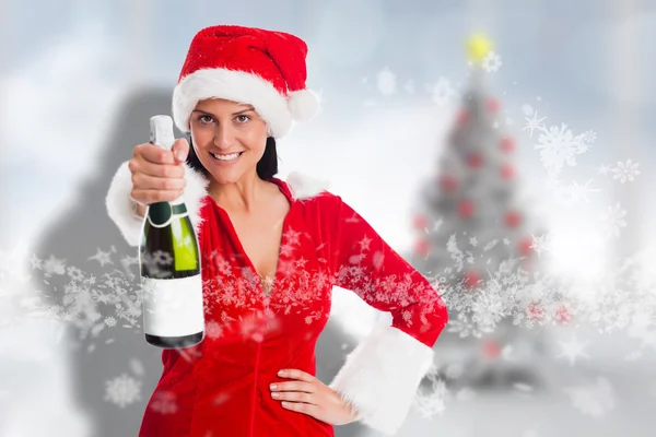 Imagen compuesta de una mujer sosteniendo una botella de champán — Foto de Stock