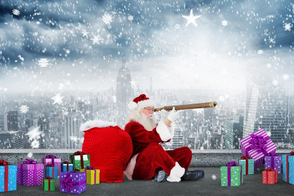 Composite image of santa looking through a telescope — Stock Photo, Image