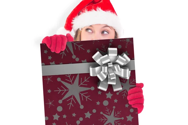 Composite image of festive blonde holding a poster — Stock Photo, Image