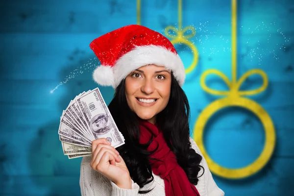 Imagen compuesta de una mujer sosteniendo algo de dinero — Foto de Stock