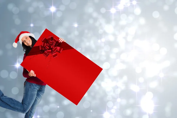 Woman holding a sign with christmas ribbon — Stock Photo, Image