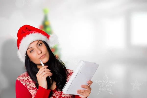 Composite image of woman thinking what to write — Stock Photo, Image