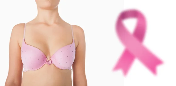 Composite image of midsection of woman in pink bra — Stock Photo, Image