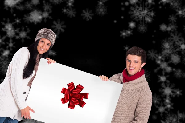 Kompositbild eines jungen Paares mit einem Plakat — Stockfoto