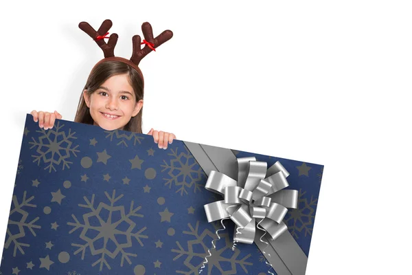 Composite image of festive little girl showing card — Stock Photo, Image