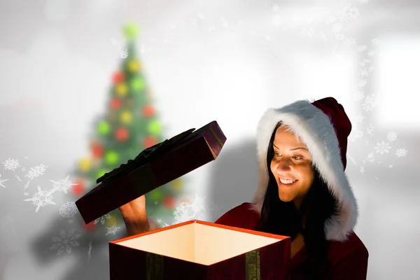 Smiling woman opening christmas present — Stock Photo, Image
