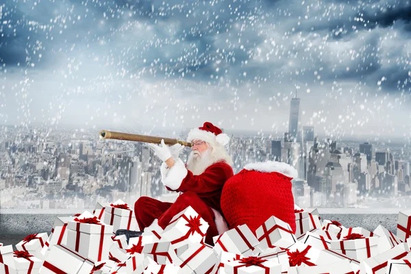 Composite image of santa looking through a telescope — Stock Photo, Image