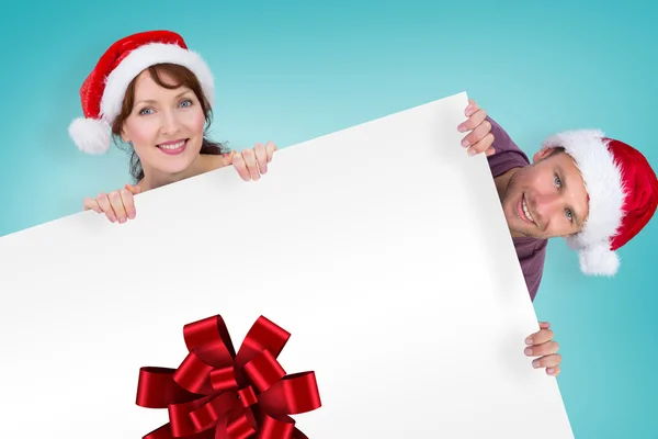 Composite image of couple both wearing santa hats — Stock Photo, Image