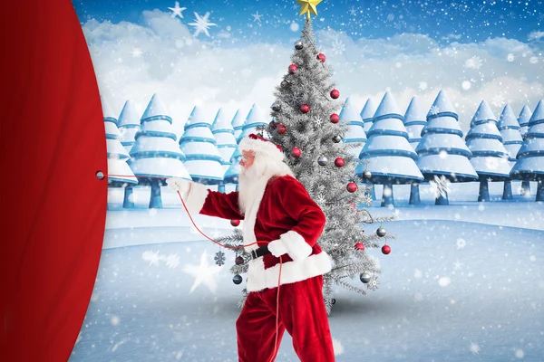 Složený obraz Santa vytáhne něco s lanem — Stock fotografie