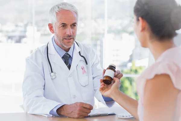 Composite image of patient holding jar of medicine — Stock Photo, Image