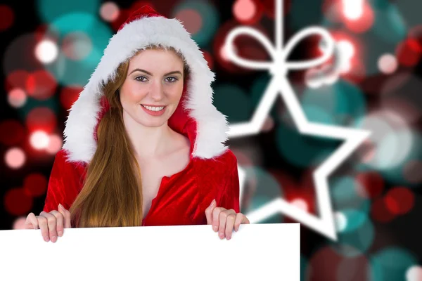 Girl in santa costume showing card — Stock Photo, Image