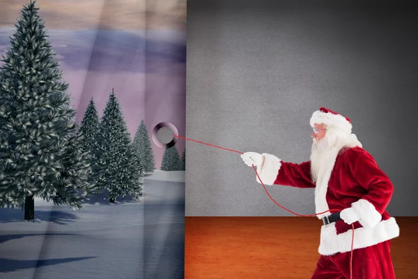 Composite image of santa pulls something with a rope — Stock Photo, Image