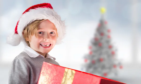 Imagen compuesta de regalo de apertura de niño festivo —  Fotos de Stock