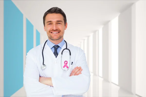 Imagem composta de jovem médico bonito com braços cruzados — Fotografia de Stock