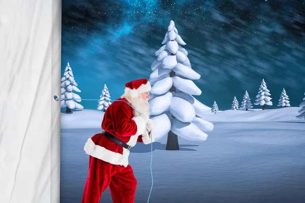 Композитное изображение Санта-Клауса, тянущего канат — стоковое фото