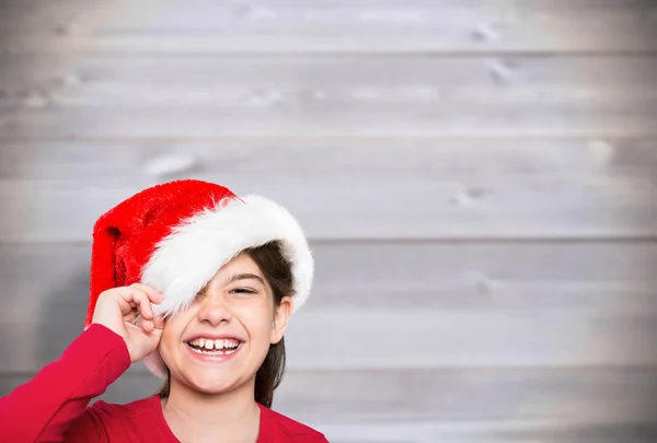 Imagem composta de menina festiva sorrindo para a câmera — Fotografia de Stock
