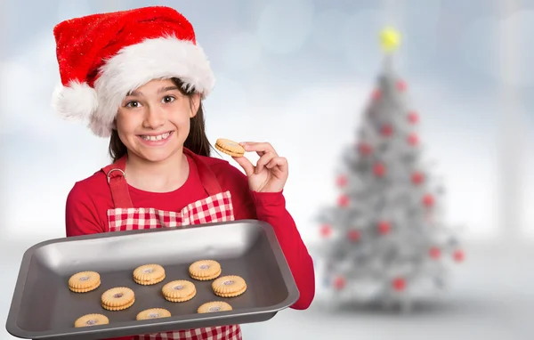 Праздничная маленькая девочка предлагает печенье — стоковое фото