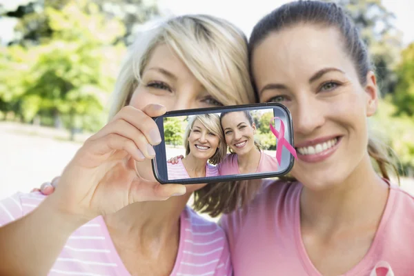 Composite image of hand holding smartphone showing — Stock Photo, Image