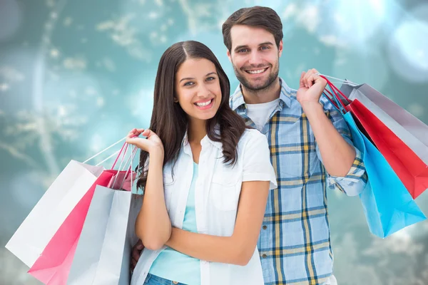 Image composite d'un couple heureux avec des sacs à provisions — Photo