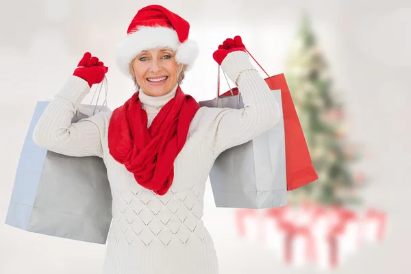 Imagem composta de mulher festiva segurando sacos de compras — Fotografia de Stock