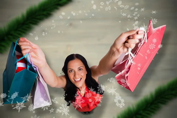 Imagem composta de mulher de pé com sacos de compras — Fotografia de Stock