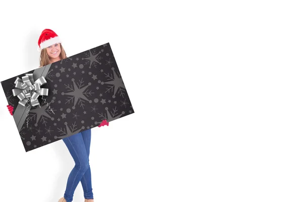 Composite image of festive blonde holding a poster — Stock Photo, Image