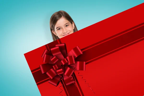 Cute girl showing card with christmas ribbon — Stock Photo, Image