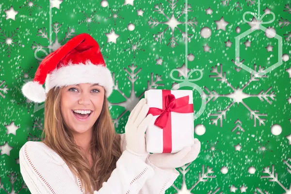 Imagem composta de loira festiva segurando um presente — Fotografia de Stock