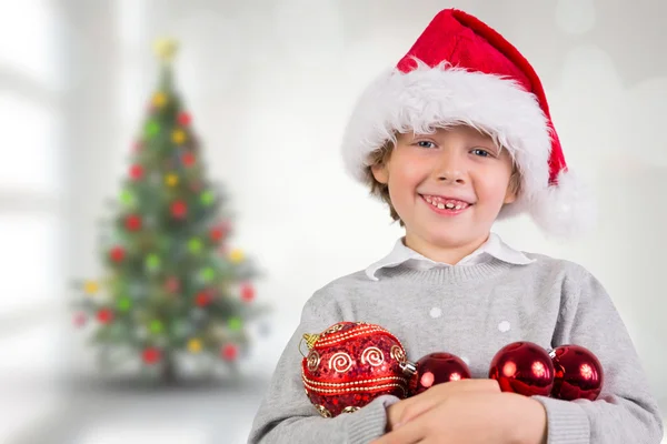 Composite image of festive boy smiling — Stock Photo, Image