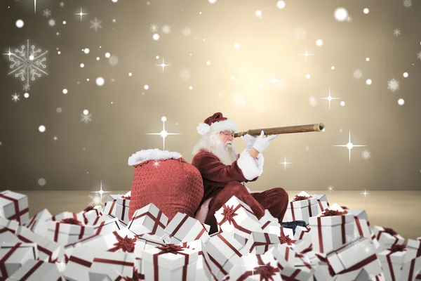 Composite image of santa looking through a telescope — Stock Photo, Image