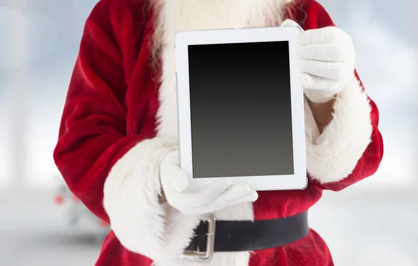 Композиция "Санта-Клаус", показывающая планшетный компьютер — стоковое фото