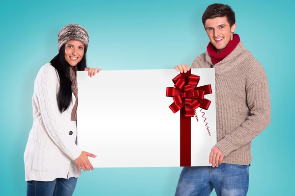 Imagem composta de jovem casal segurando um cartaz — Fotografia de Stock