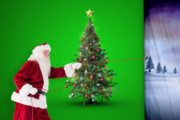 Composite image of santa pulls something with a rope — Stock Photo, Image