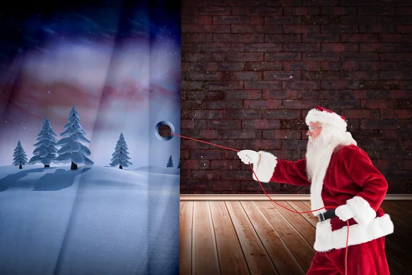 Composite image of santa pulls something with a rope — Stock Photo, Image