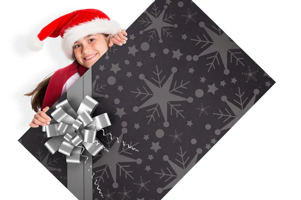 Composite image of festive little girl showing card — Stock Photo, Image