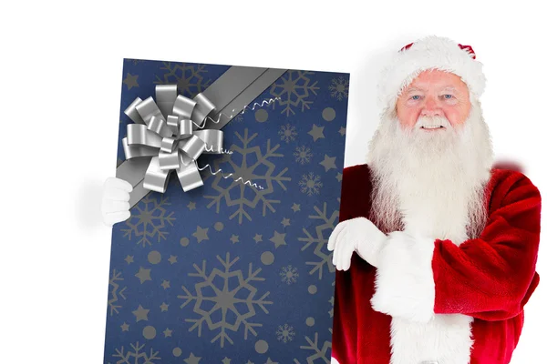 Composite image of santa claus showing blackboard — Stock Photo, Image