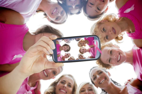 Composite image of hand holding smartphone showing — Stock Photo, Image